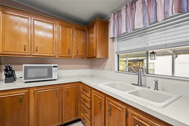 a kitchen with stainless steel appliances granite countertop a sink and a cabinets