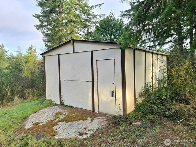 a backyard of a house with plants and tree