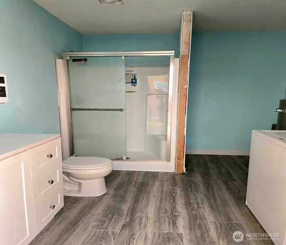 a view of a field with trees in the background