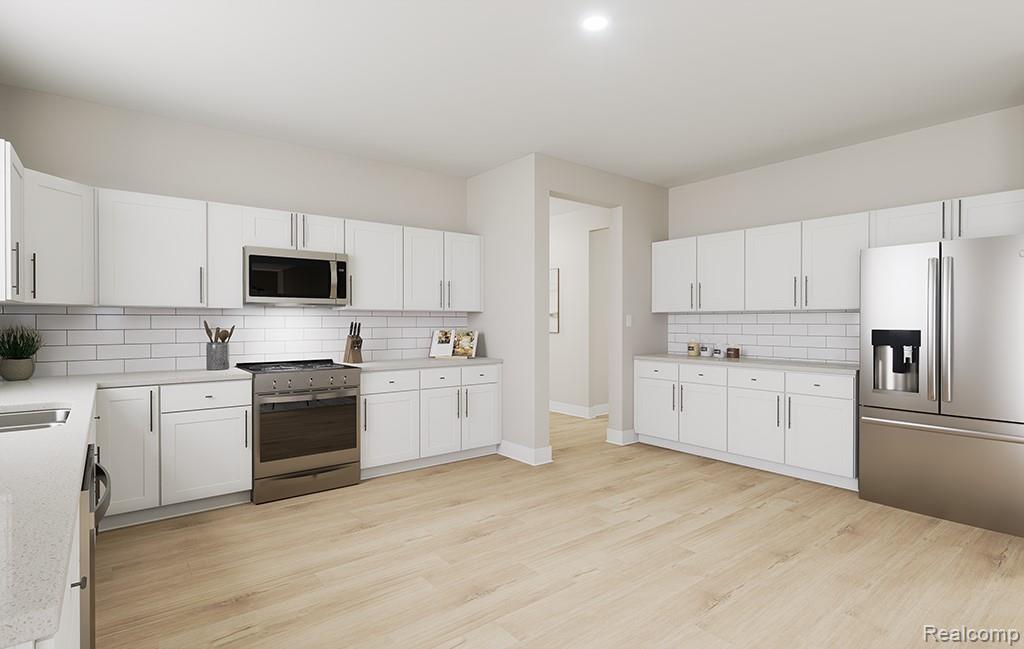61659 Empire Road South Lyon, MI 48178 - Photo 13 of 21 Kitchen featuring stainless steel appliances, decorative backsplash, white cabinetry, light wood-type flooring, and light stone countertops