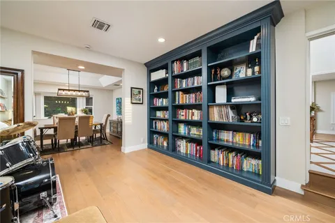 a living room with lots of furniture and a book shelf