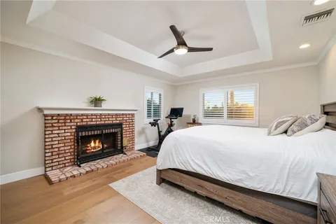 a bedroom with a bed and a fireplace