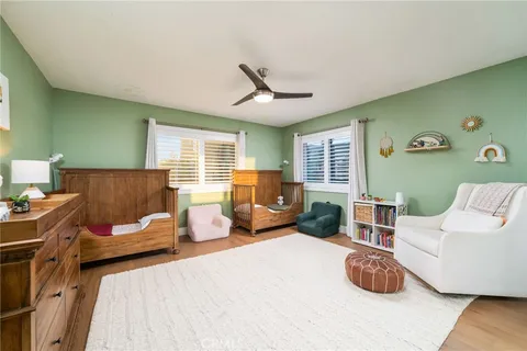 a bedroom with furniture and a large window