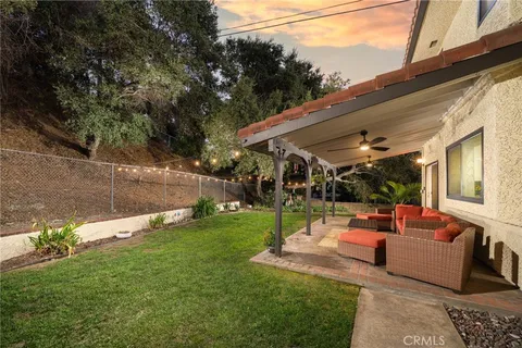 a view of a patio with couches chairs and a yard