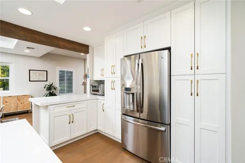 a kitchen with stainless steel appliances a refrigerator sink and cabinets