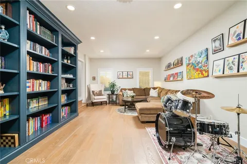 a living room with furniture and a book shelf
