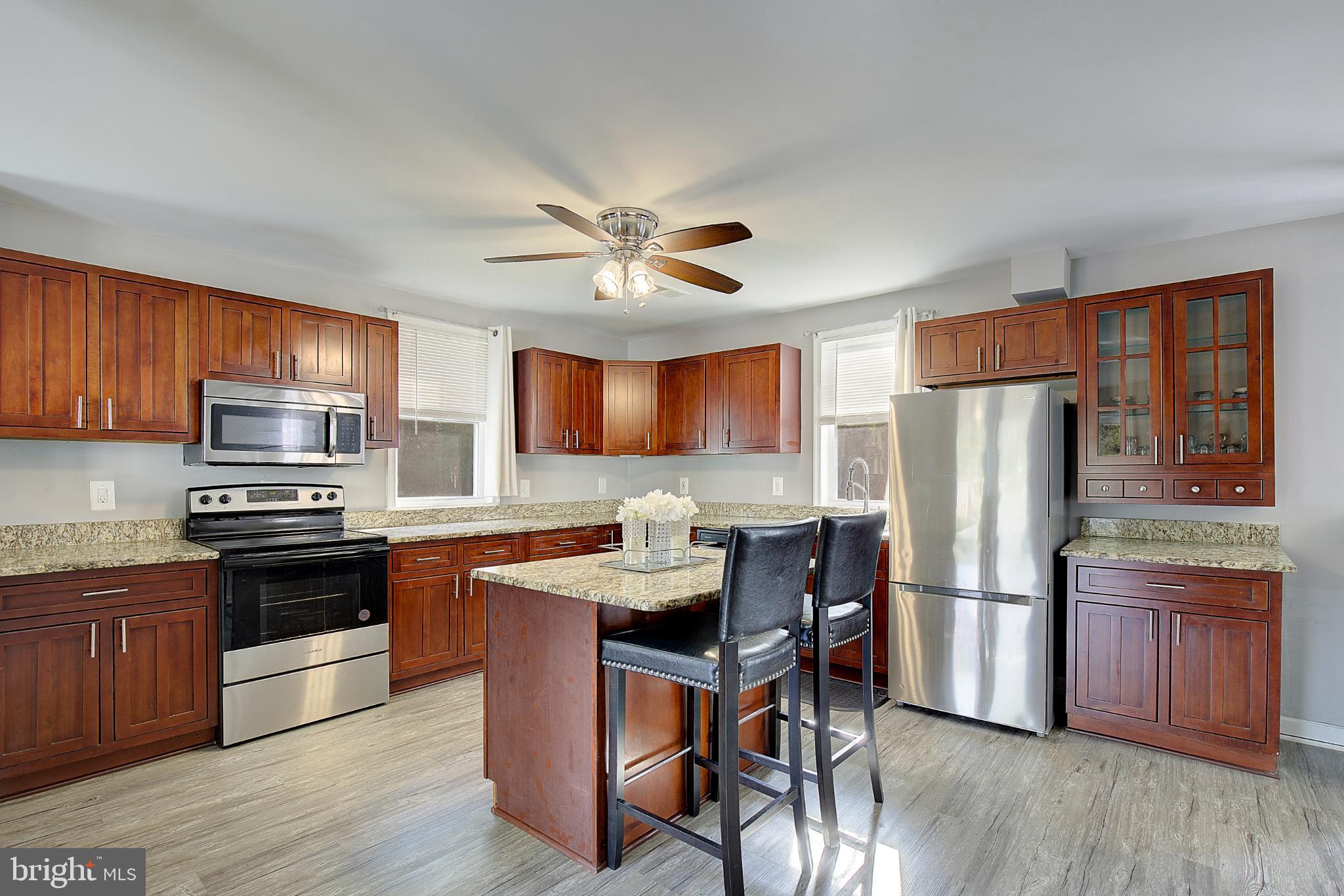 16811 Aquasco Road Brandywine, MD 20613 - Photo 11 of 34 Modern kitchen with rich wood cabinetry.