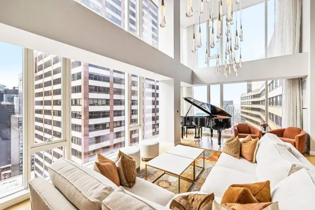 a living room with furniture and a chandelier