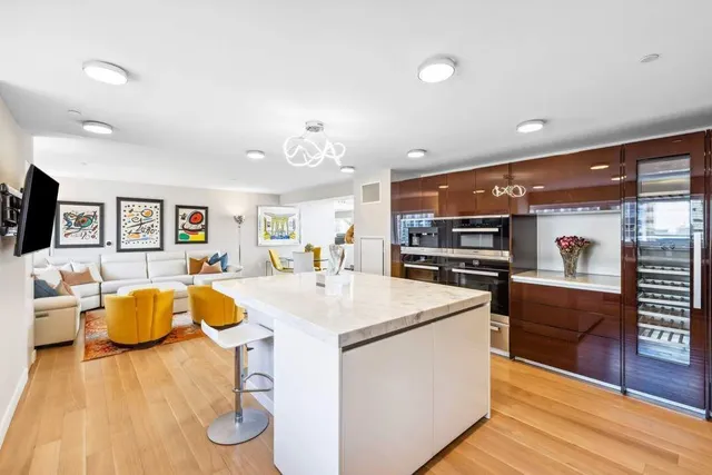 a living room with furniture kitchen view and a table
