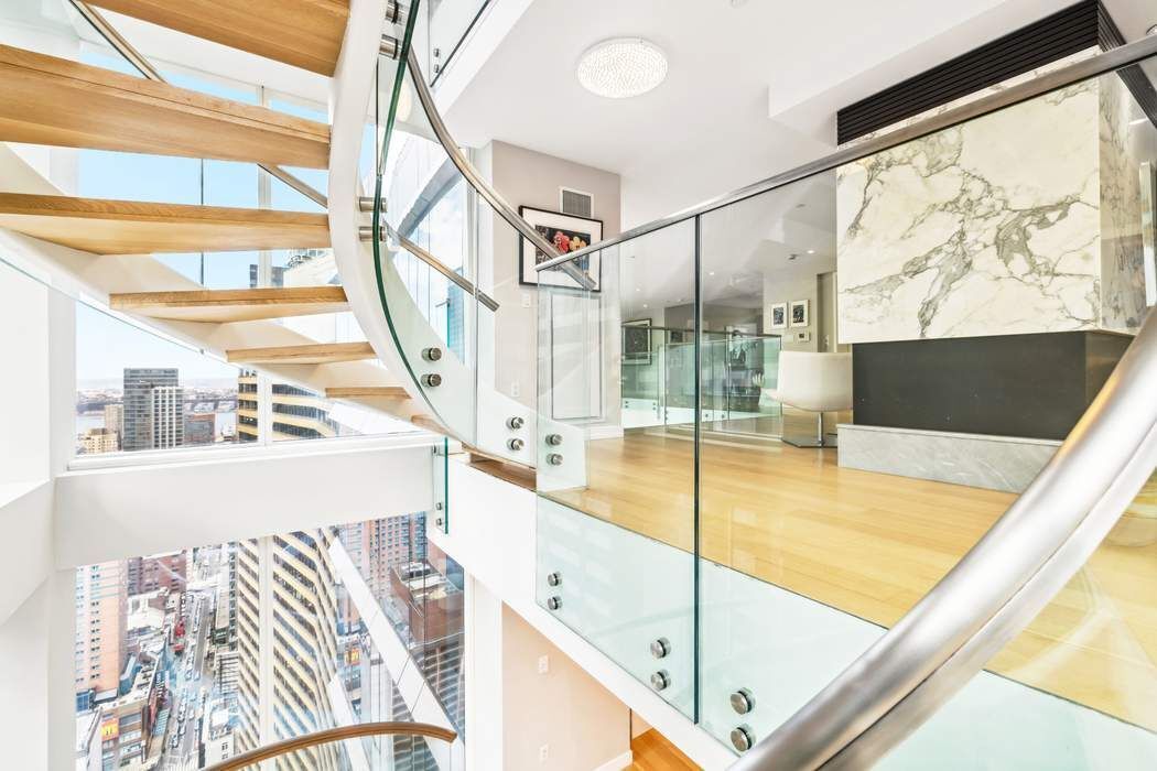 135 West 52nd Street, Unit PH1 Manhattan, NY 10019 - Photo 7 of 29 a view of an indoor swimming pool