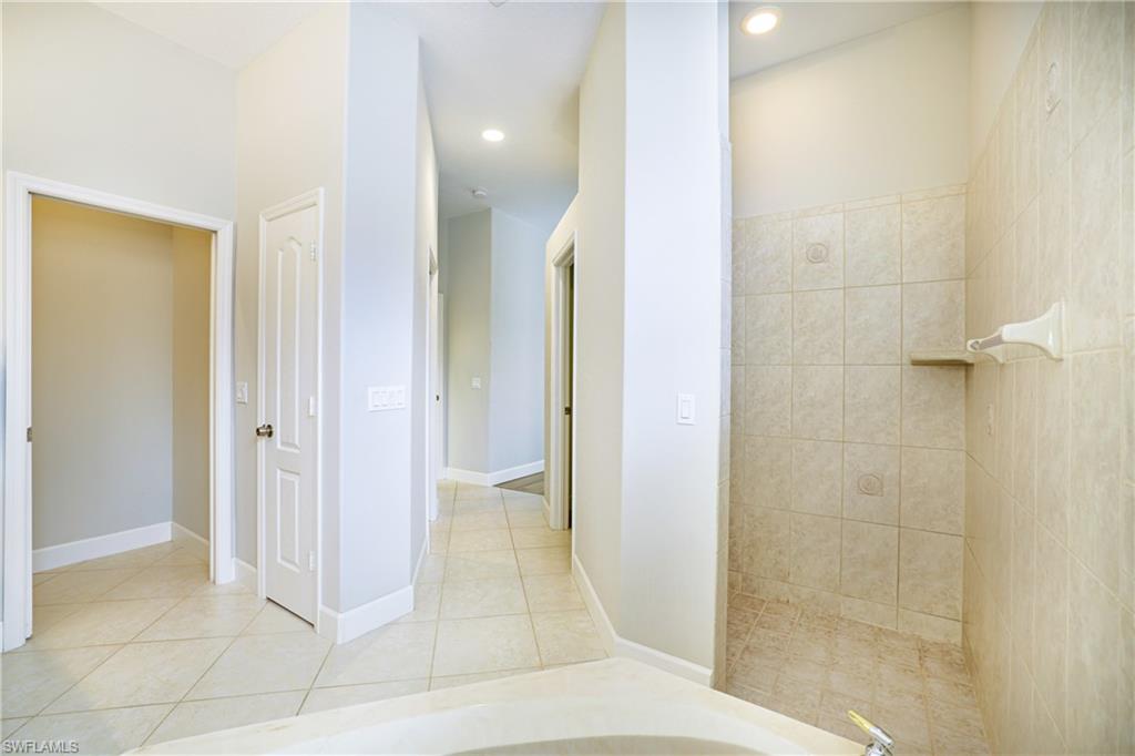 5235 Malvern Court Naples, FL 34112 - Photo 16 of 28 a bathroom with a shower and a sink