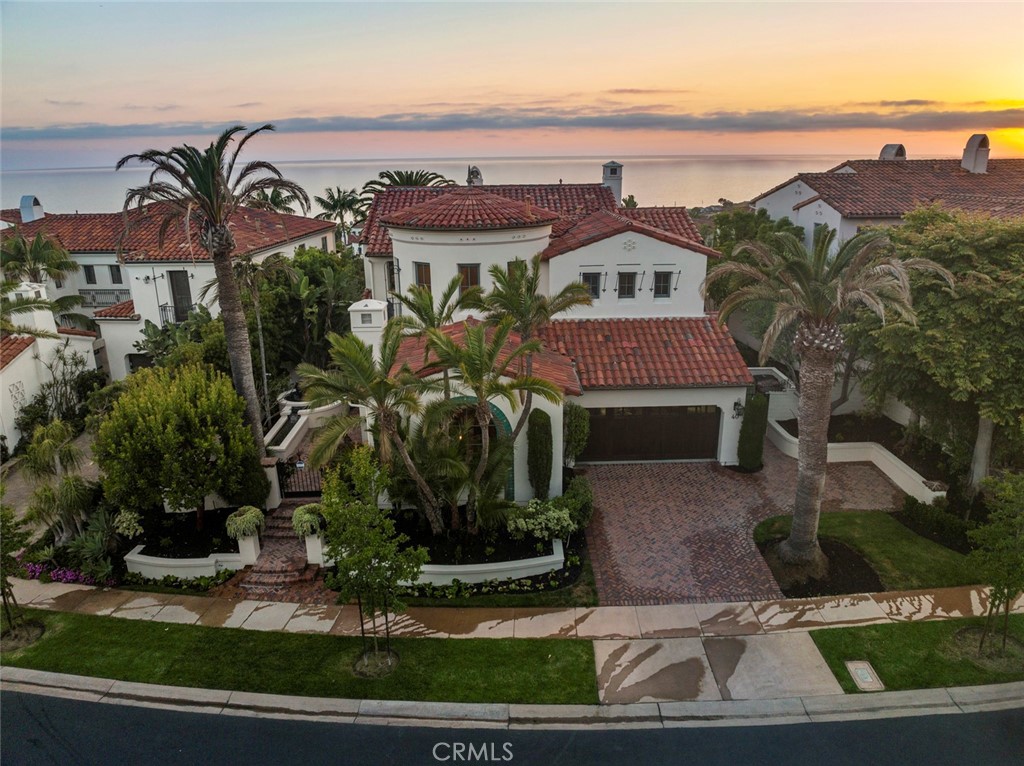 40 Timor Sea Newport Coast, CA 92657 - Photo 2 of 50 a view of a white house with a clock tower in front of it