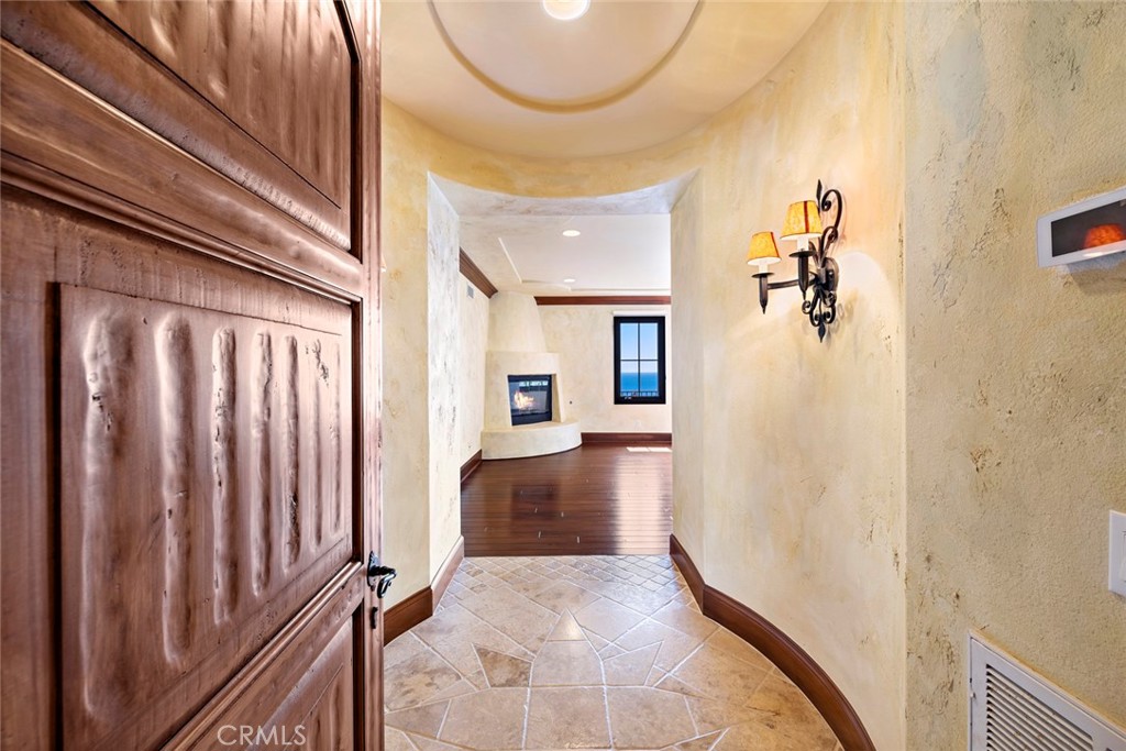 40 Timor Sea Newport Coast, CA 92657 - Photo 25 of 50 a view of a hallway with wooden floor and staircase
