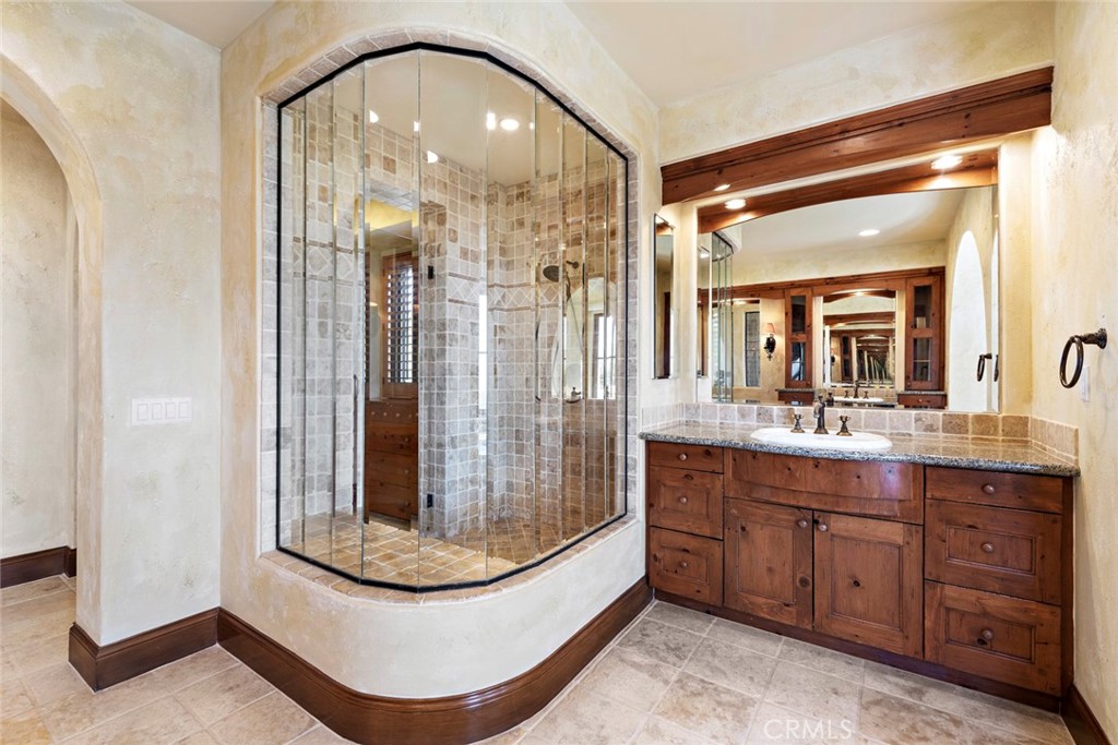 40 Timor Sea Newport Coast, CA 92657 - Photo 32 of 50 a bathroom with a mirror a double vanity sink and glass door
