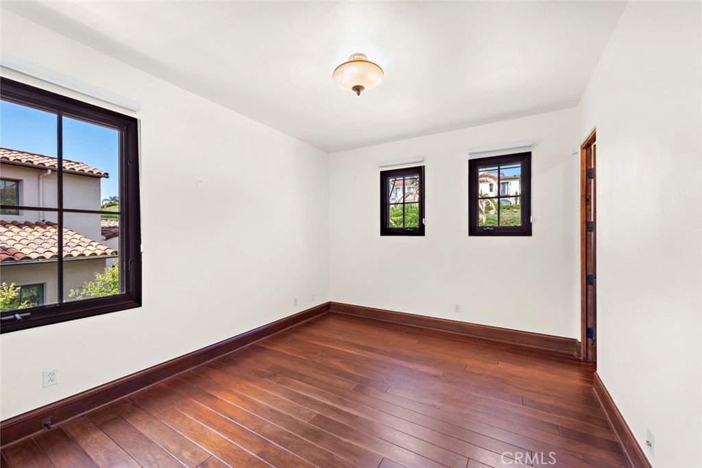 40 Timor Sea Newport Coast, CA 92657 - Photo 40 of 50 an empty room with wooden floor and windows