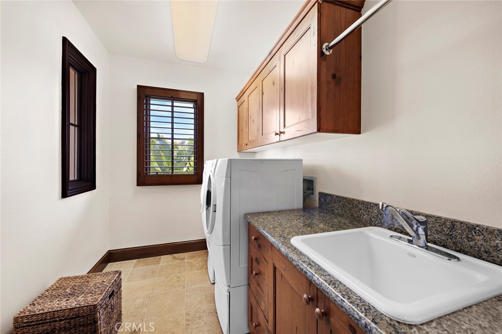 40 Timor Sea Newport Coast, CA 92657 - Photo 42 of 50 a bathroom with a granite countertop sink and a bathtub