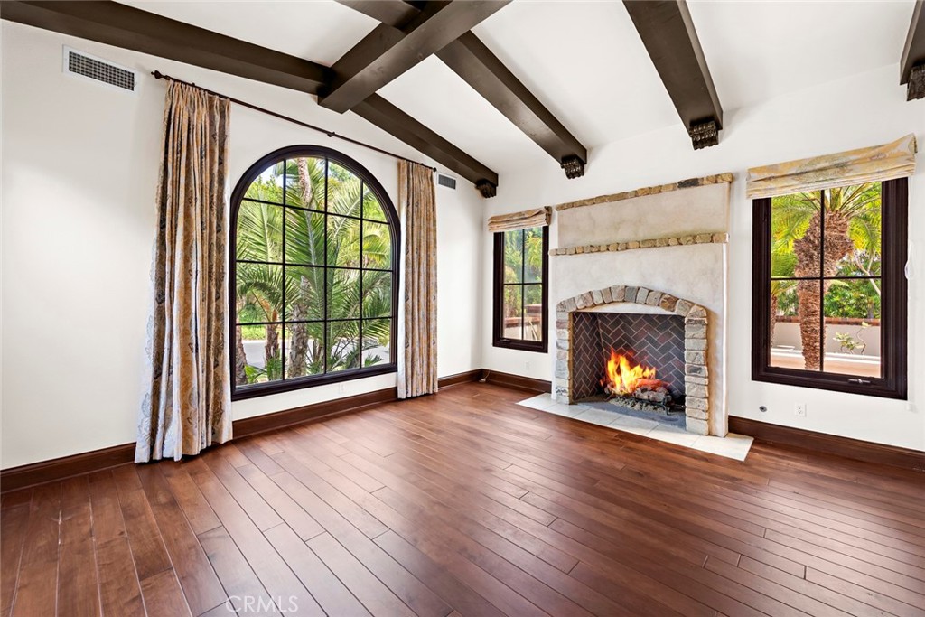 40 Timor Sea Newport Coast, CA 92657 - Photo 7 of 50 a view of an empty room with wooden floor fireplace and a window