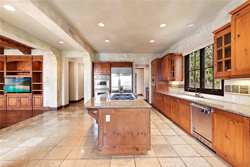 40 Timor Sea Newport Coast, CA 92657 - Photo 8 of 50 a large kitchen with stainless steel appliances granite countertop a large counter top and a sink
