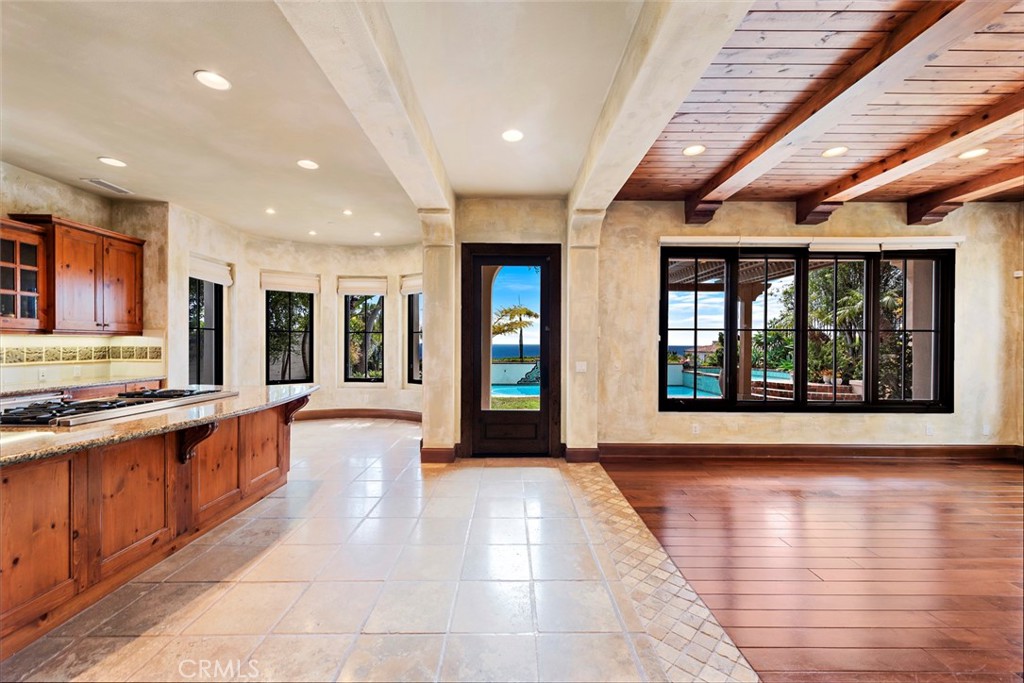 40 Timor Sea Newport Coast, CA 92657 - Photo 10 of 50 a large kitchen with stainless steel appliances granite countertop a large stove top oven and a dishwasher next to a large window