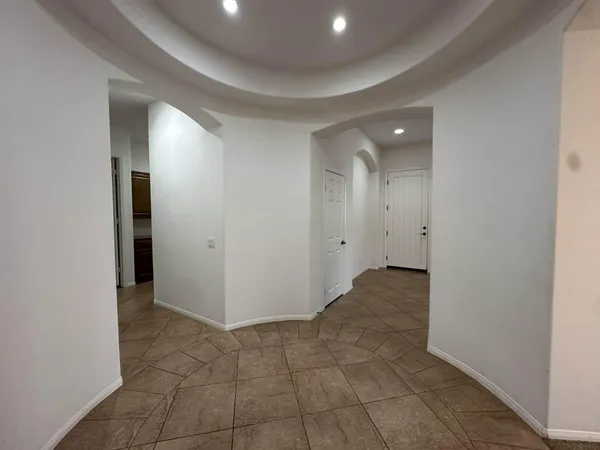 a view of hallway with a bathroom and a sink