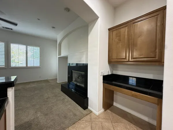a kitchen with a refrigerator and a stove top oven