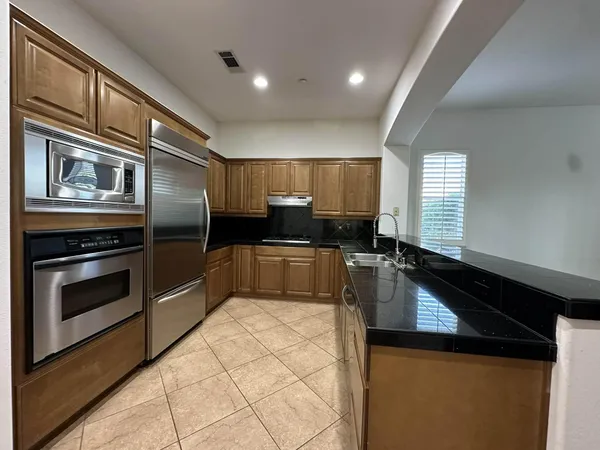 a kitchen with a sink cabinets and stainless steel appliances