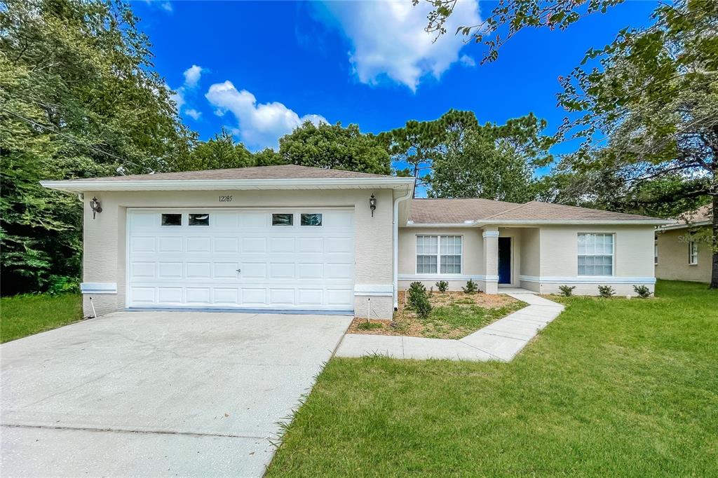 Undisclosed Address Spring Hill, FL 34609 - Photo 1 of 1 front view of a house with a yard