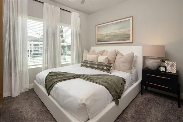 a large bed sitting in a bedroom next to a window
