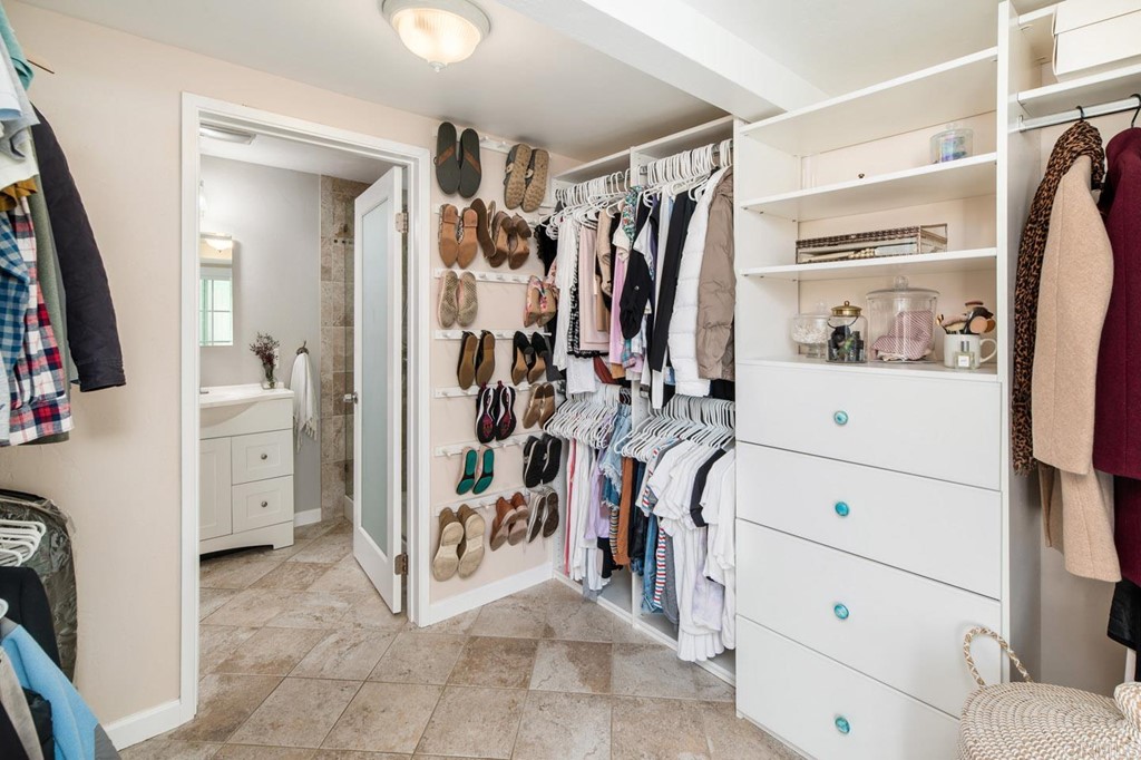 220 Coneflower Street Encinitas, CA 92024 - Photo 15 of 25 a view of walk in closet with clothes and shoes