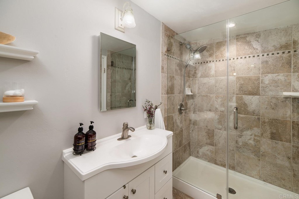 220 Coneflower Street Encinitas, CA 92024 - Photo 16 of 25 a bathroom with a sink a toilet and shower
