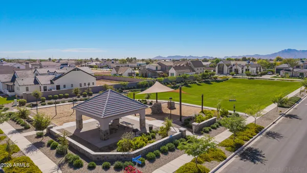 an aerial view of a house with a garden and lake view