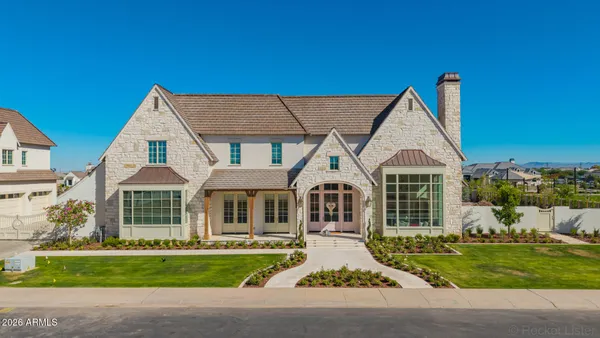 a front view of a house with a garden