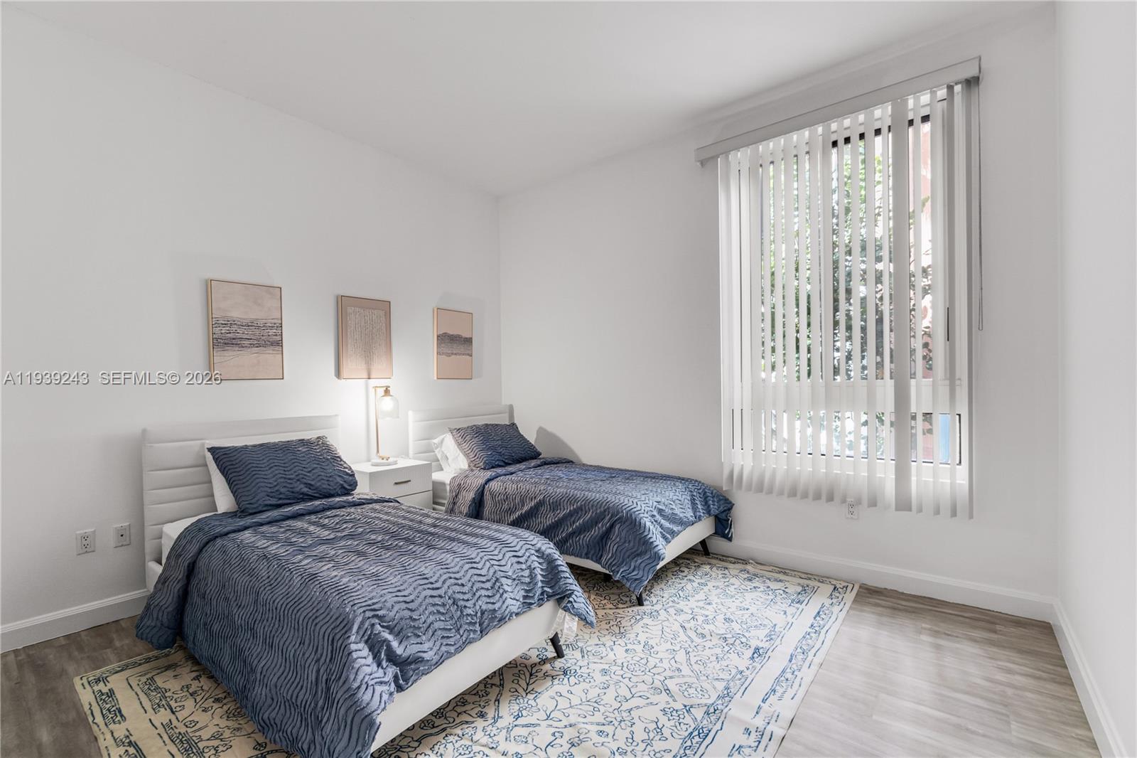 785 Crandon Boulevard, Unit 106 Key Biscayne, FL 33149 - Photo 11 of 22 a bedroom with two beds and a window