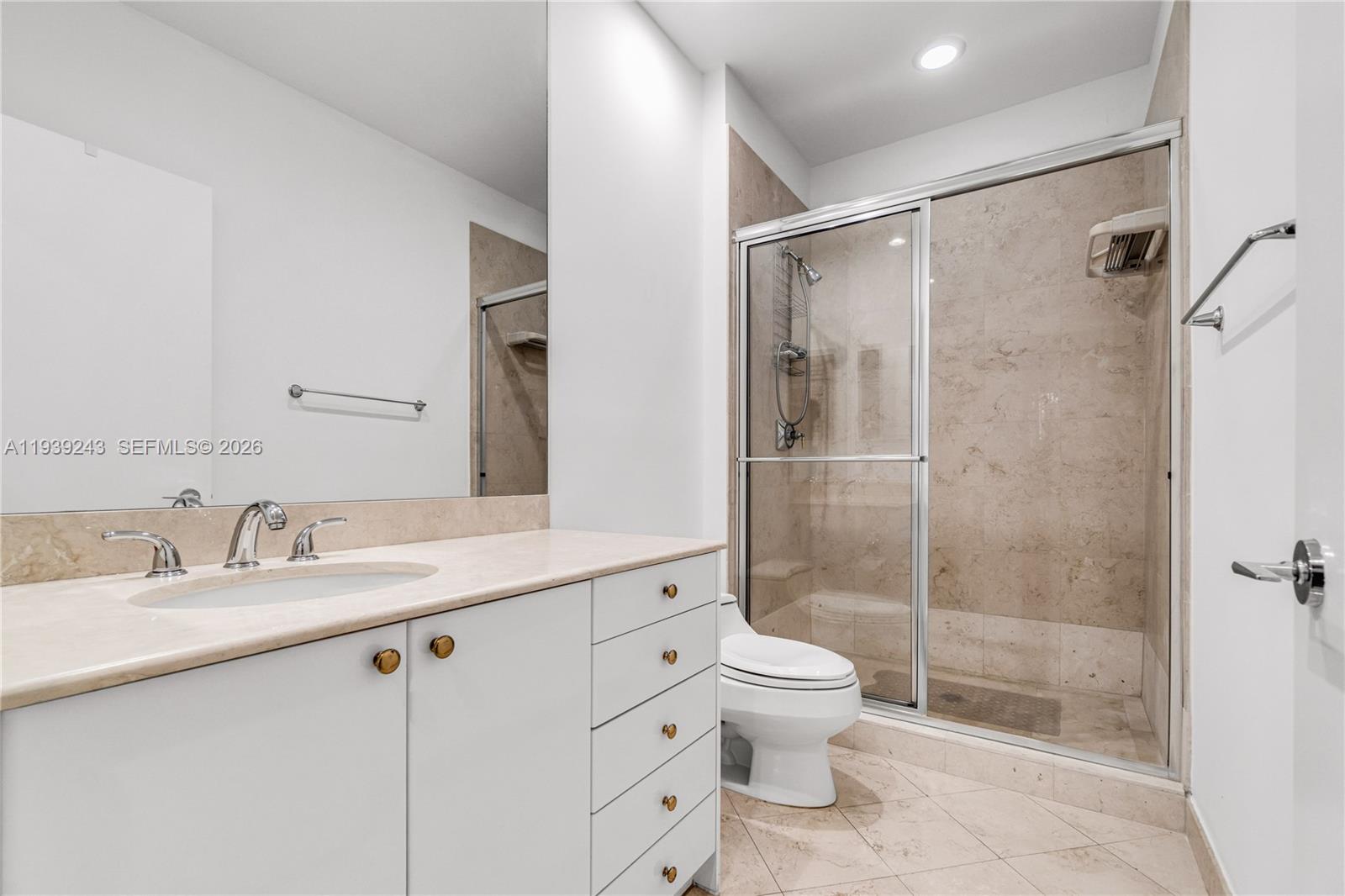 785 Crandon Boulevard, Unit 106 Key Biscayne, FL 33149 - Photo 12 of 22 a bathroom with a granite countertop sink toilet and shower