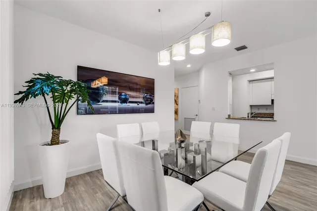 a view of a dining room with furniture and a potted plant