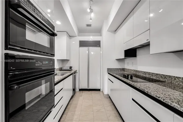 a kitchen with stainless steel appliances granite countertop a stove and a sink