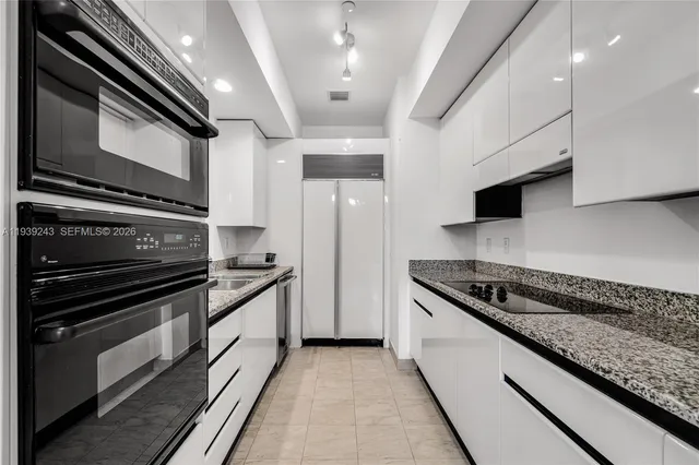 a kitchen with stainless steel appliances granite countertop a stove and a sink