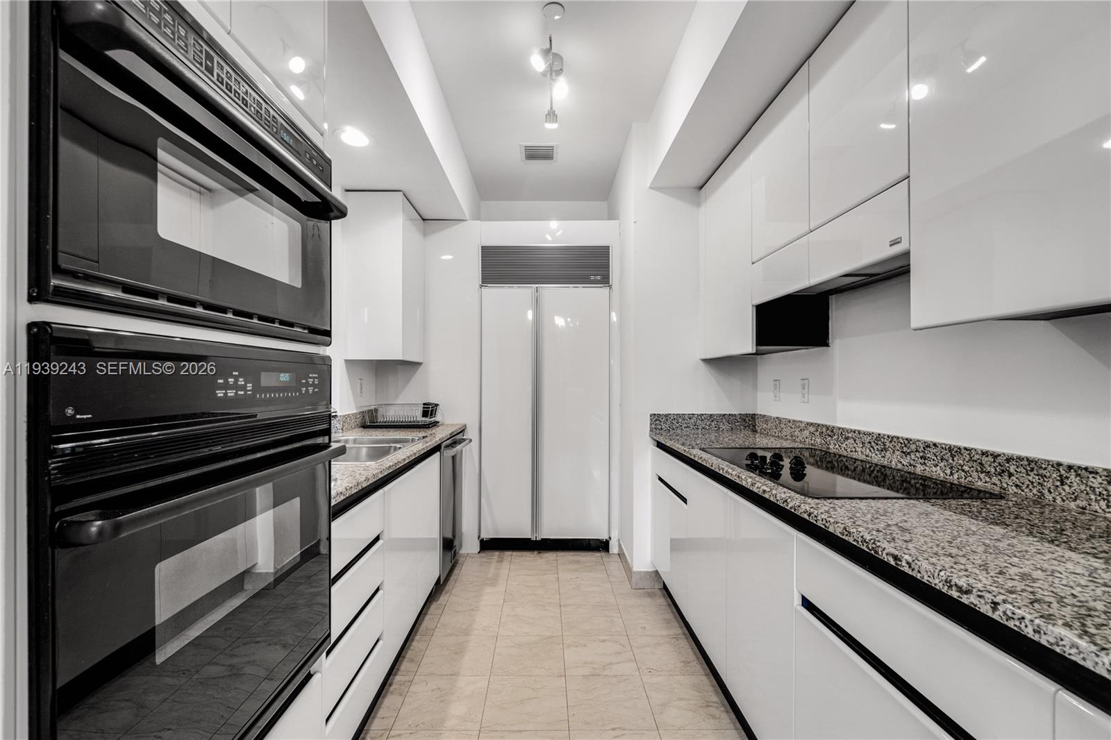 785 Crandon Boulevard, Unit 106 Key Biscayne, FL 33149 - Photo 6 of 22 a kitchen with stainless steel appliances granite countertop a stove and a sink