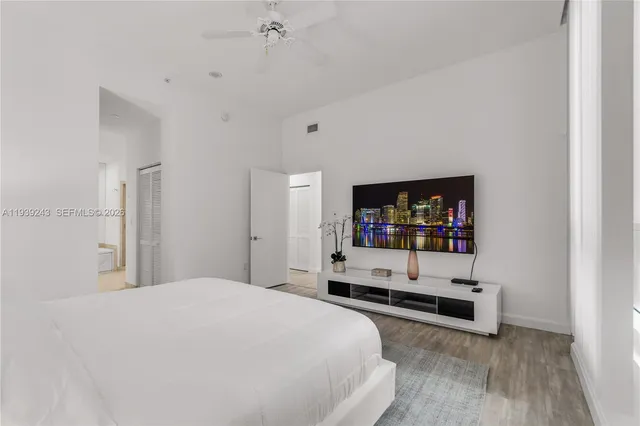 a bedroom with a white bed and white walls