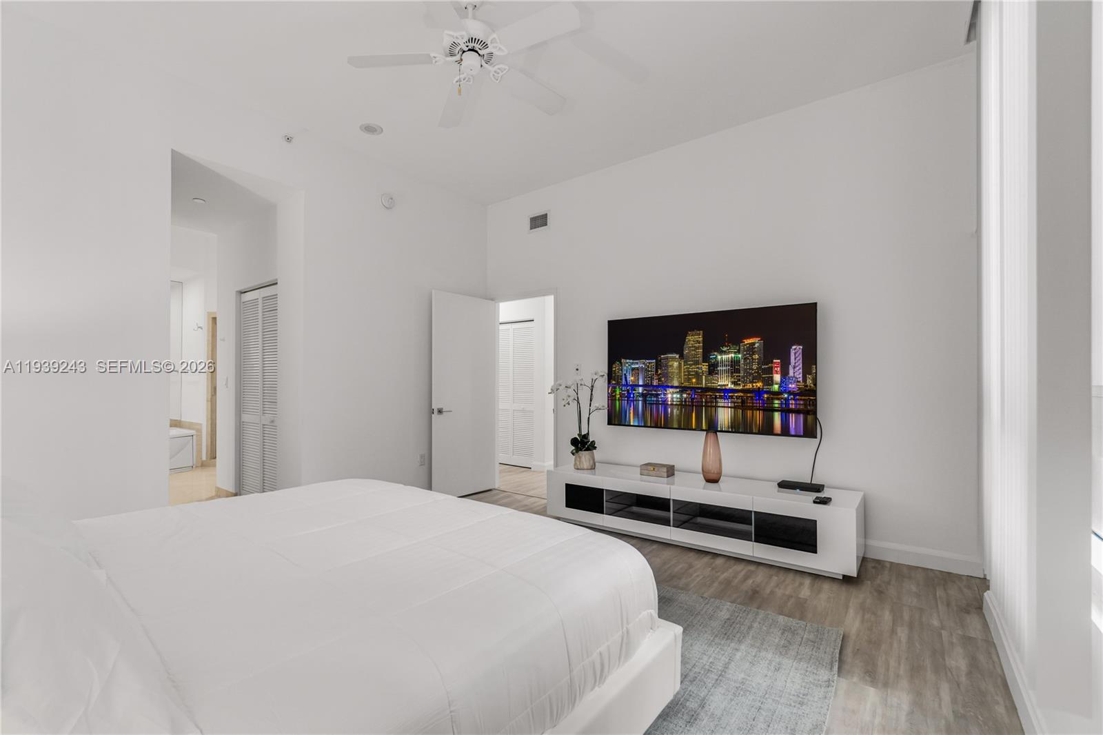 785 Crandon Boulevard, Unit 106 Key Biscayne, FL 33149 - Photo 9 of 22 a bedroom with a white bed and white walls