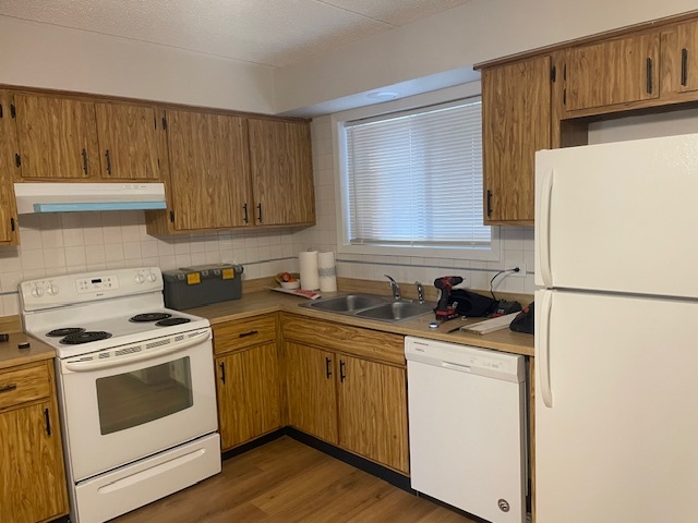 950 North Rohlwing Road, Unit 101A Addison, IL 60101 - Photo 3 of 7 a kitchen with a white cabinets and white appliances