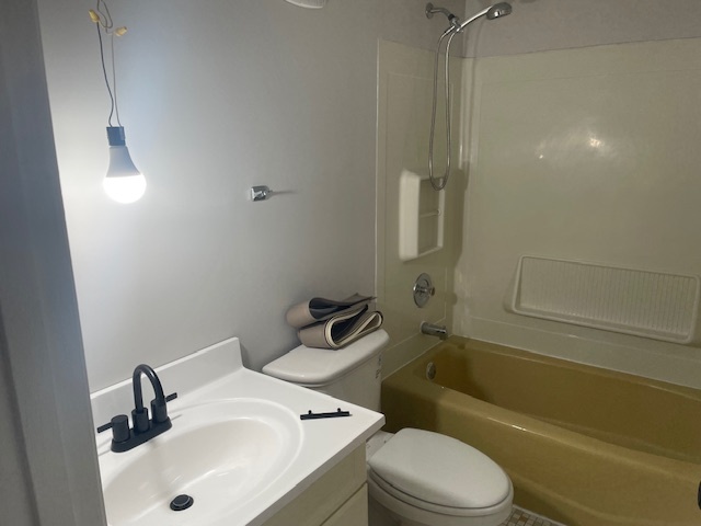 950 North Rohlwing Road, Unit 101A Addison, IL 60101 - Photo 7 of 7 a bathroom with a sink a toilet and shower