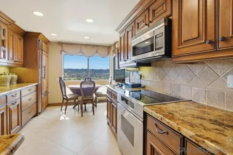 a kitchen with stainless steel appliances granite countertop a sink and cabinets