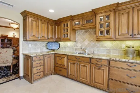 a kitchen with stainless steel appliances granite countertop a sink and cabinets