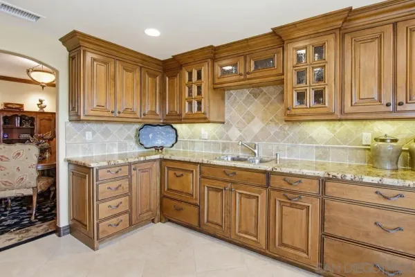 a kitchen with stainless steel appliances granite countertop a sink and cabinets
