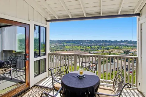 a view of a balcony with a table and chairs