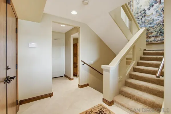 a bedroom with a bed potted plant and cabinets