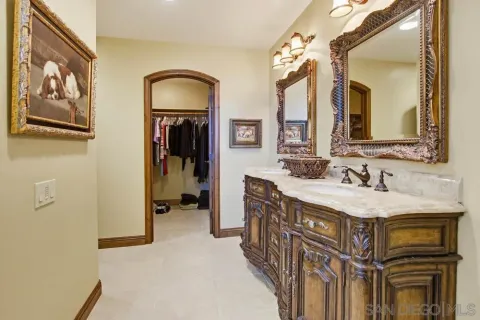 a view of walk in closet with clothes