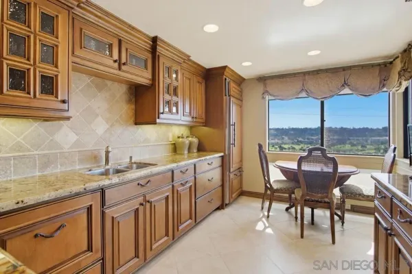 a view of a kitchen with granite countertop lots of counter top space and furniture