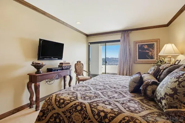 a bedroom with a bed and a lamp